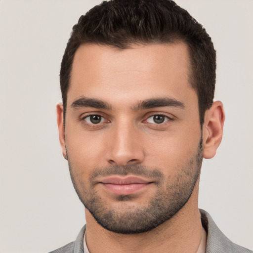 Joyful white young-adult male with short  black hair and brown eyes