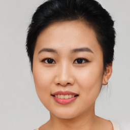 Joyful asian young-adult female with short  black hair and brown eyes