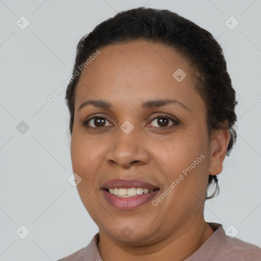 Joyful black adult female with short  black hair and brown eyes