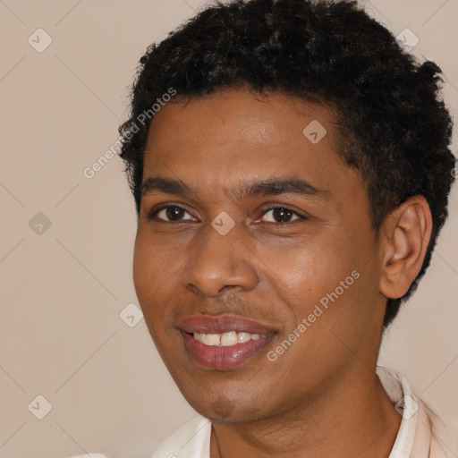 Joyful black young-adult male with short  black hair and brown eyes