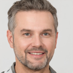 Joyful white adult male with short  brown hair and grey eyes