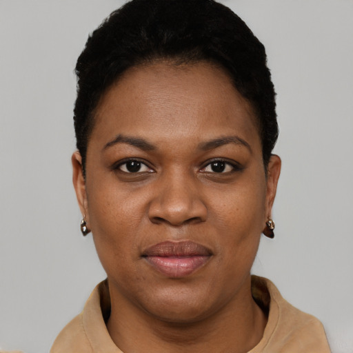 Joyful black young-adult female with short  brown hair and brown eyes