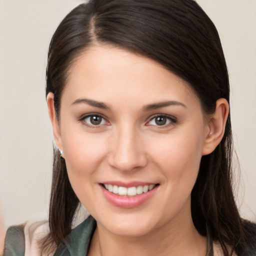 Joyful white young-adult female with long  brown hair and brown eyes