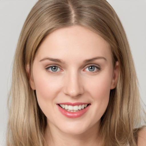 Joyful white young-adult female with long  brown hair and grey eyes