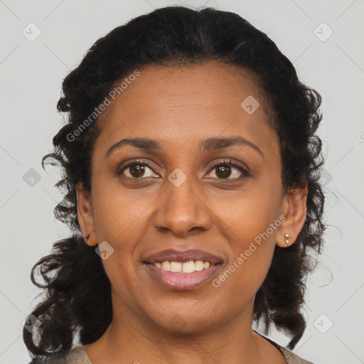 Joyful black adult female with medium  brown hair and brown eyes