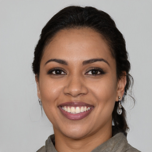 Joyful latino young-adult female with medium  black hair and brown eyes