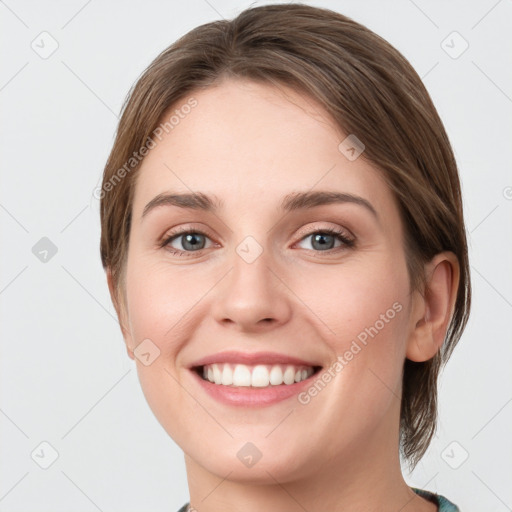 Joyful white young-adult female with medium  brown hair and green eyes