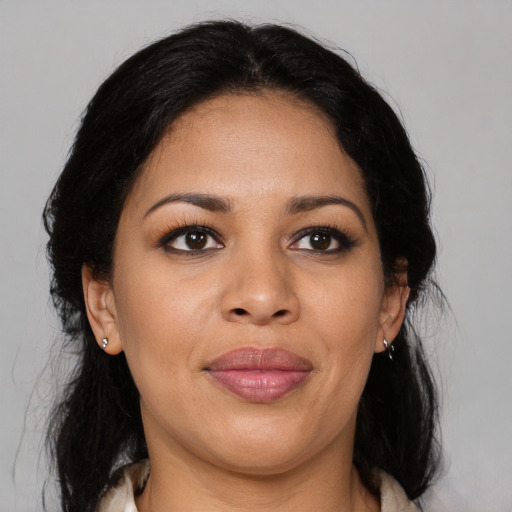 Joyful latino young-adult female with medium  brown hair and brown eyes