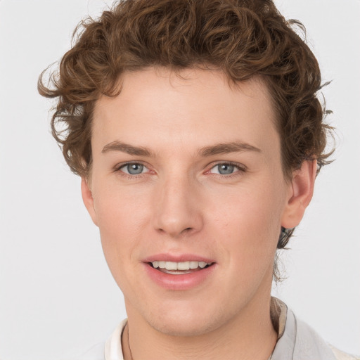 Joyful white young-adult male with short  brown hair and blue eyes