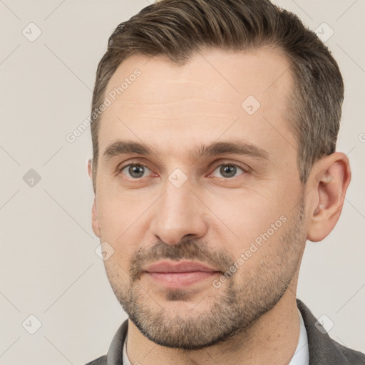 Joyful white adult male with short  brown hair and brown eyes