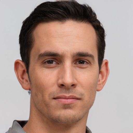 Joyful white young-adult male with short  brown hair and brown eyes