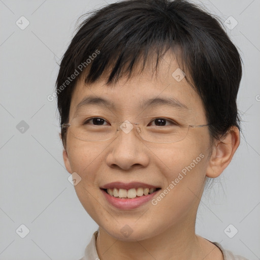 Joyful asian young-adult female with short  brown hair and brown eyes