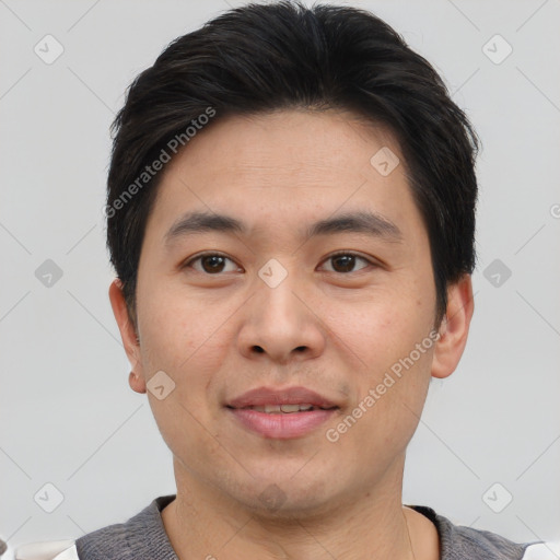 Joyful asian young-adult male with short  brown hair and brown eyes