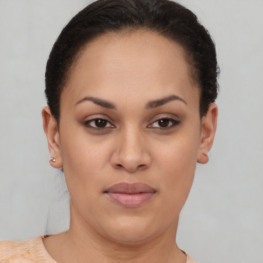 Joyful latino young-adult female with short  brown hair and brown eyes