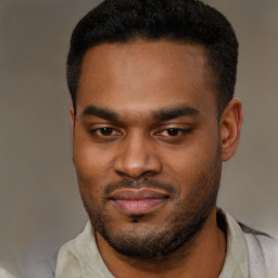 Joyful latino young-adult male with short  brown hair and brown eyes