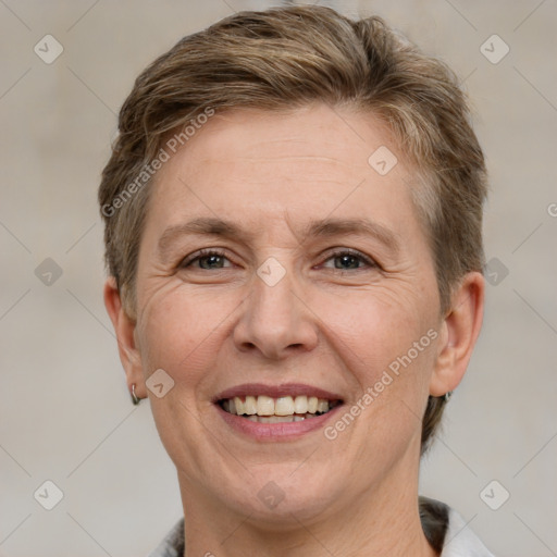 Joyful white adult female with short  brown hair and grey eyes