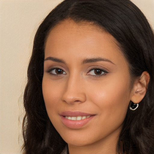 Joyful latino young-adult female with long  brown hair and brown eyes