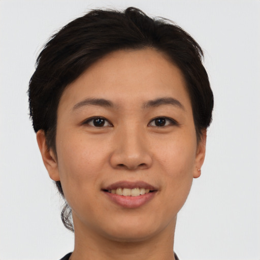 Joyful asian young-adult female with short  brown hair and brown eyes