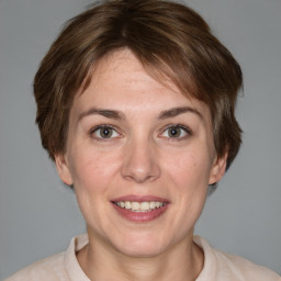 Joyful white adult female with medium  brown hair and grey eyes