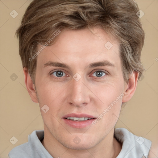 Joyful white young-adult male with short  brown hair and grey eyes