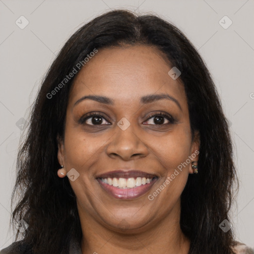 Joyful black young-adult female with long  brown hair and brown eyes