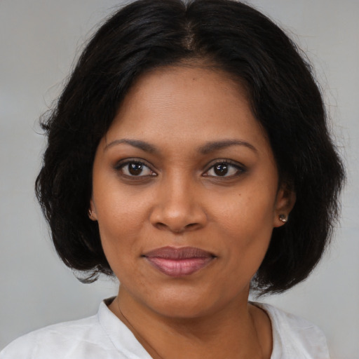 Joyful black young-adult female with medium  black hair and brown eyes