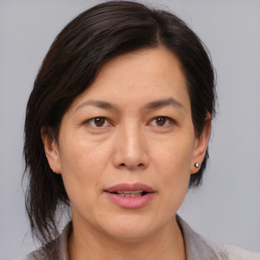 Joyful asian adult female with medium  brown hair and brown eyes