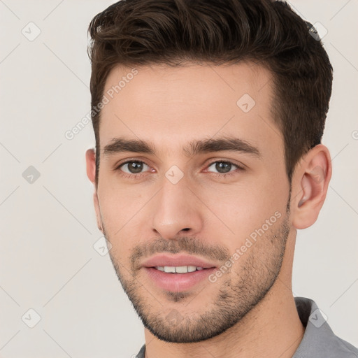 Joyful white young-adult male with short  brown hair and brown eyes