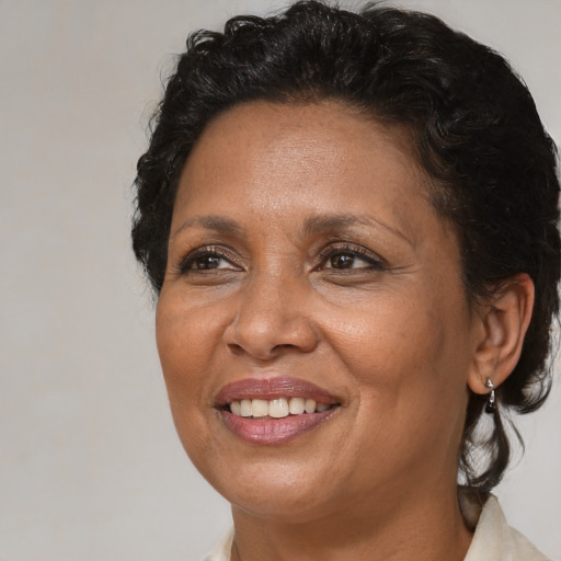 Joyful black adult female with short  brown hair and brown eyes