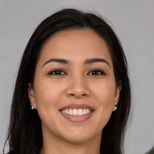 Joyful white young-adult female with long  brown hair and brown eyes