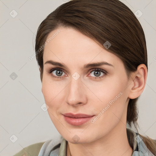 Joyful white young-adult female with medium  brown hair and grey eyes