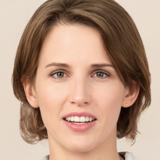 Joyful white young-adult female with medium  brown hair and green eyes