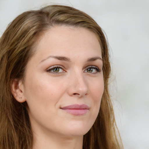 Joyful white young-adult female with long  brown hair and green eyes