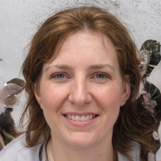 Joyful white adult female with medium  brown hair and grey eyes