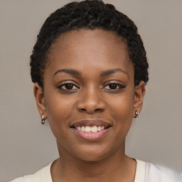 Joyful black young-adult female with short  black hair and brown eyes