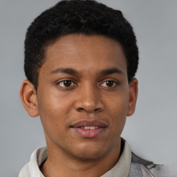 Joyful black young-adult male with short  brown hair and brown eyes