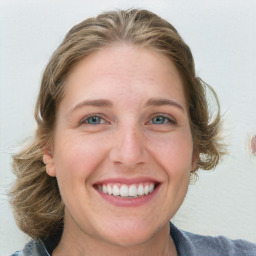 Joyful white young-adult female with medium  brown hair and blue eyes