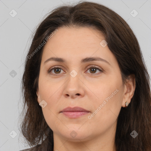 Joyful white adult female with long  brown hair and brown eyes