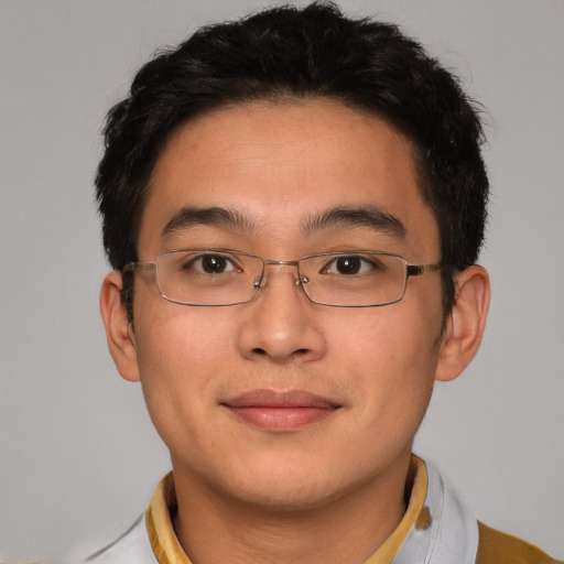 Joyful asian young-adult male with short  brown hair and brown eyes