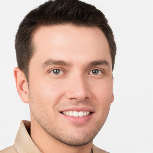 Joyful white young-adult male with short  brown hair and brown eyes