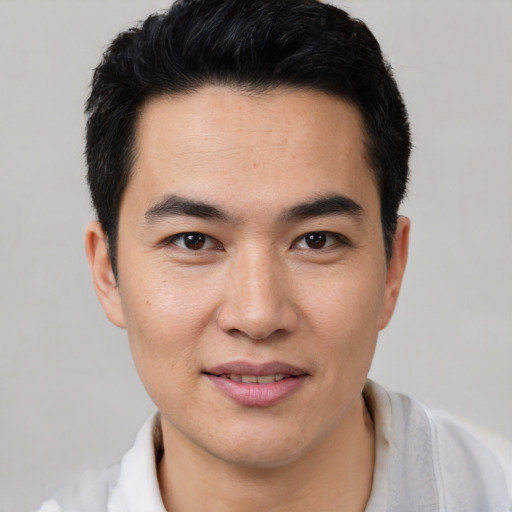 Joyful latino young-adult male with short  black hair and brown eyes