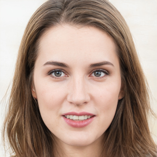 Joyful white young-adult female with long  brown hair and grey eyes