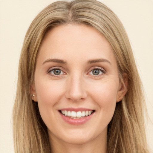 Joyful white young-adult female with long  brown hair and green eyes