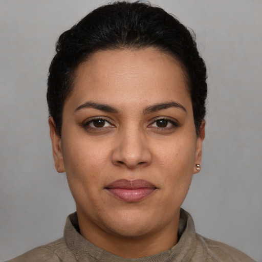 Joyful latino young-adult female with short  brown hair and brown eyes