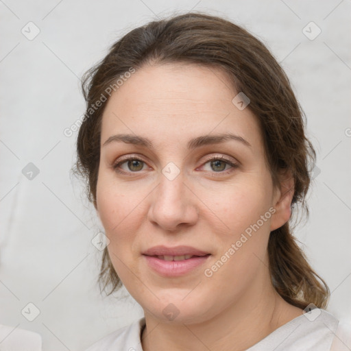 Joyful white young-adult female with medium  brown hair and green eyes