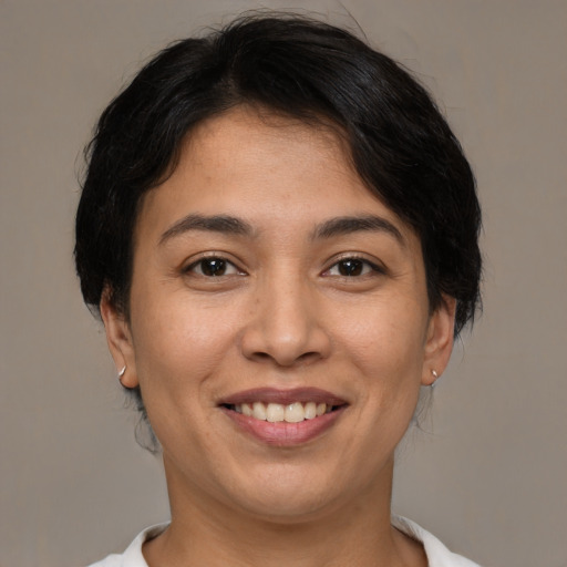 Joyful latino young-adult female with medium  brown hair and brown eyes