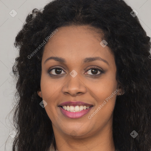 Joyful black young-adult female with long  brown hair and brown eyes