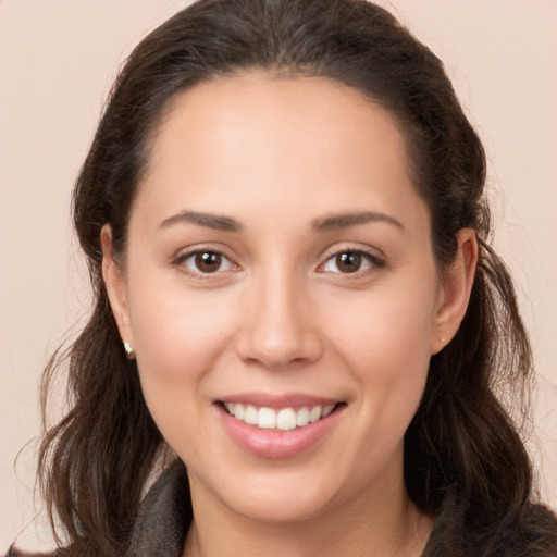 Joyful white young-adult female with long  brown hair and brown eyes