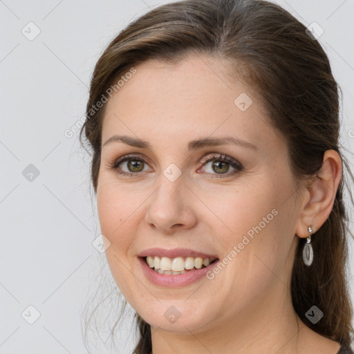 Joyful white young-adult female with long  brown hair and grey eyes