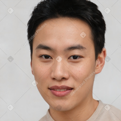 Joyful asian young-adult male with short  black hair and brown eyes